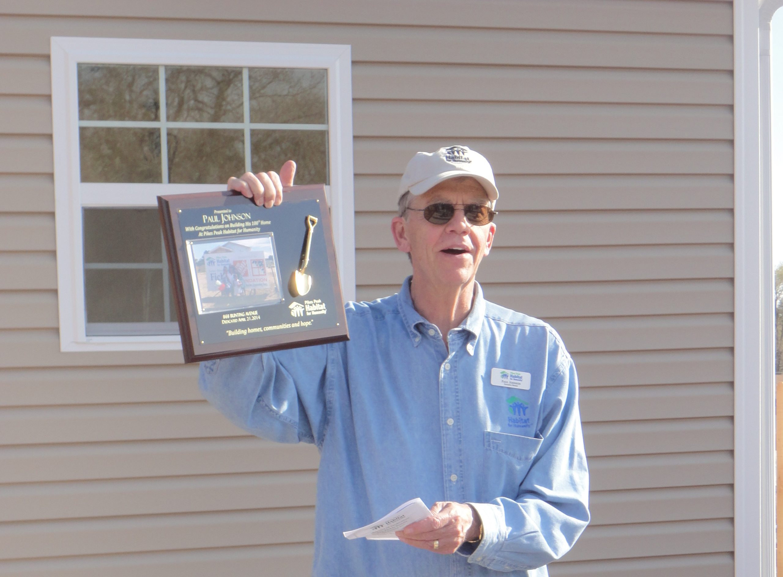 Man holding plaque