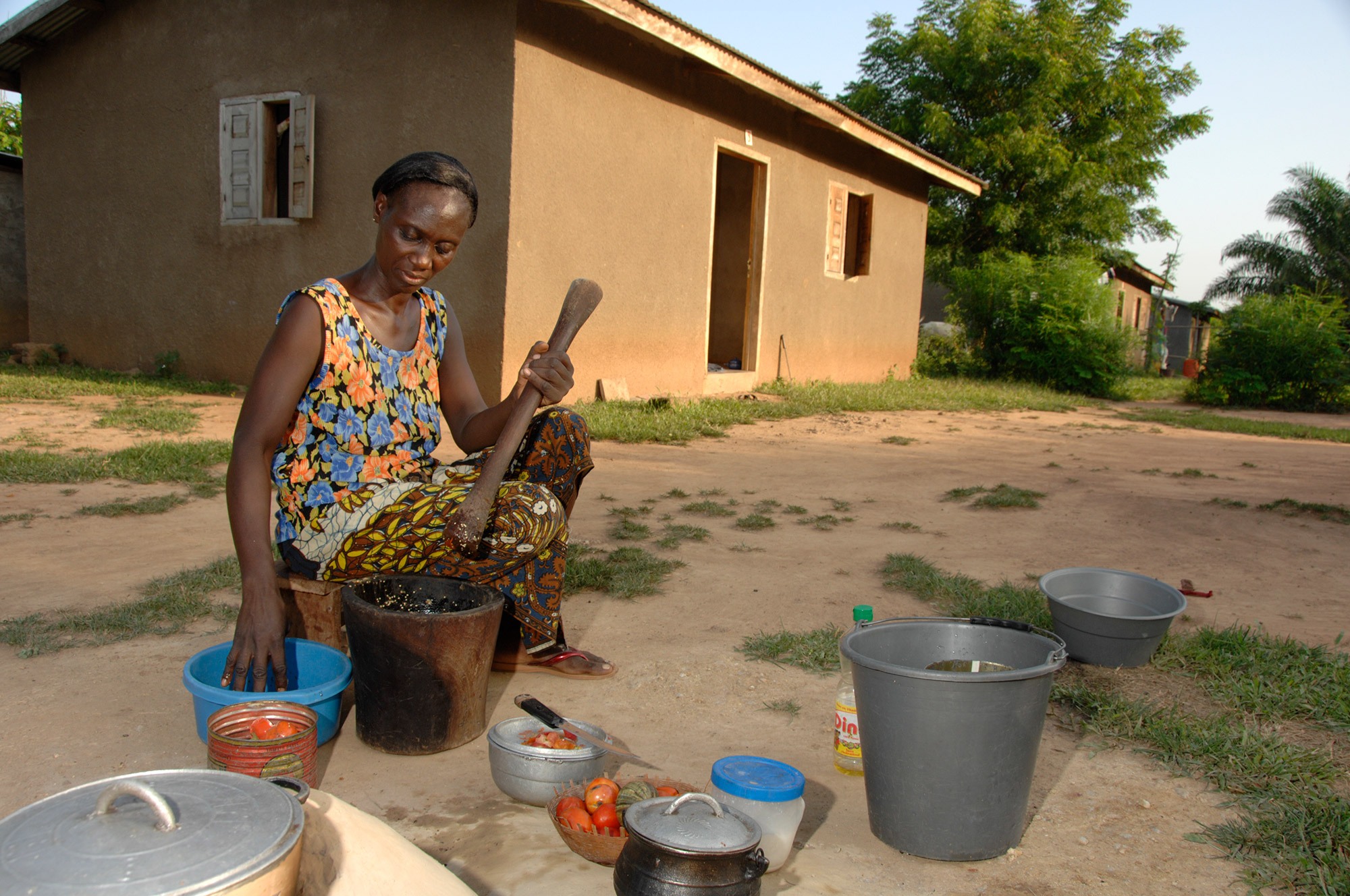 Woman preparing food outside a home