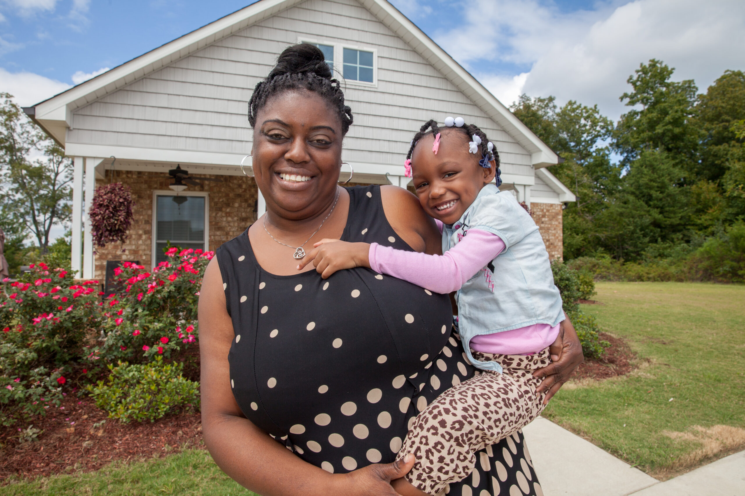 BIRMINGHAM, AL, USA (9/17/15)- Pratina Woods and her three-year-old granddaughter, Jhonna Florence, at their home in Birmingham, Alabama.  This was a blessing to me, says Pratina, I have always dreamed of being a homeowner.  Embassy Homes built Pratinas house during Habitats 2014 Home Builders Blitz. ©Habitat for Humanity International/Jason Asteros