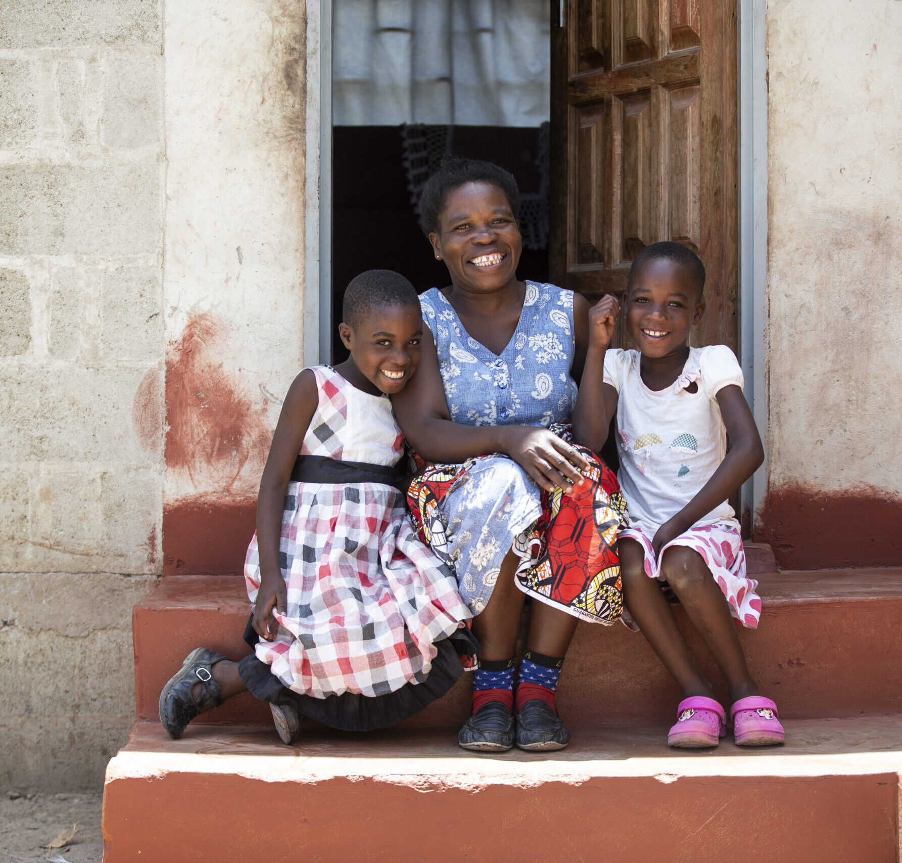 Woman and children on doorstep in Zambia