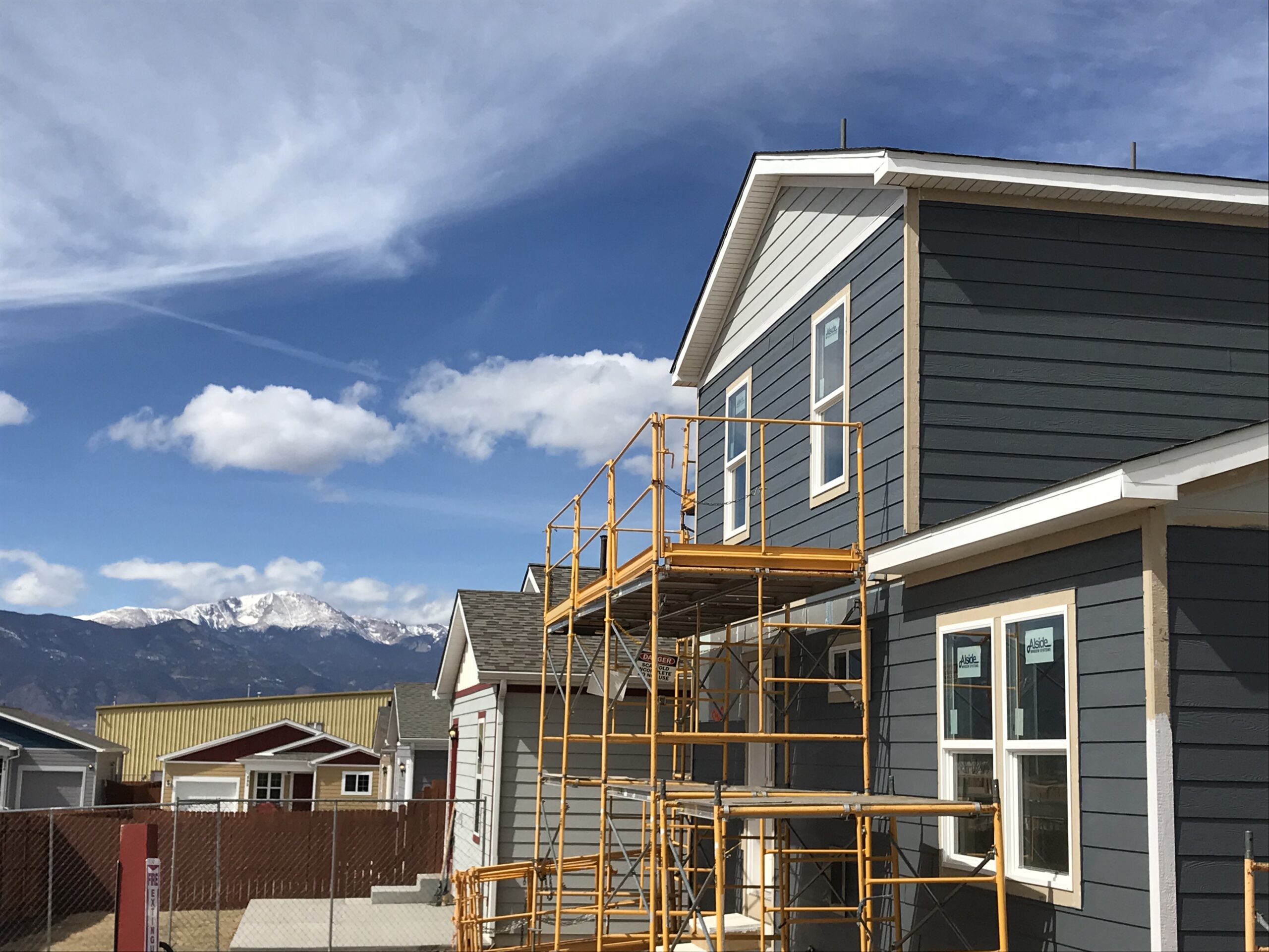 House with scaffolding and mountains in background