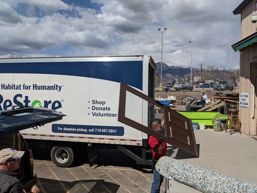 ReStore employee unloading a door