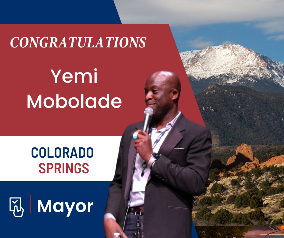 Congratulations Yemi Mobolade, photo of him speaking with Pikes Peak in background