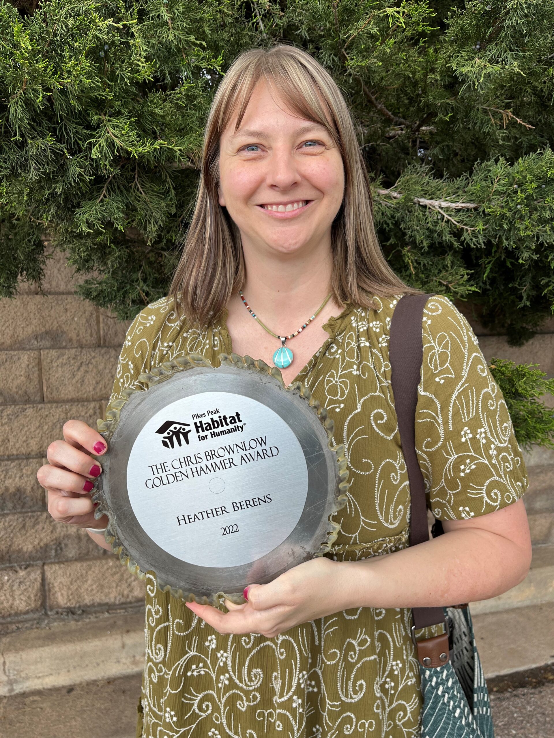 Smiling woman holding an award