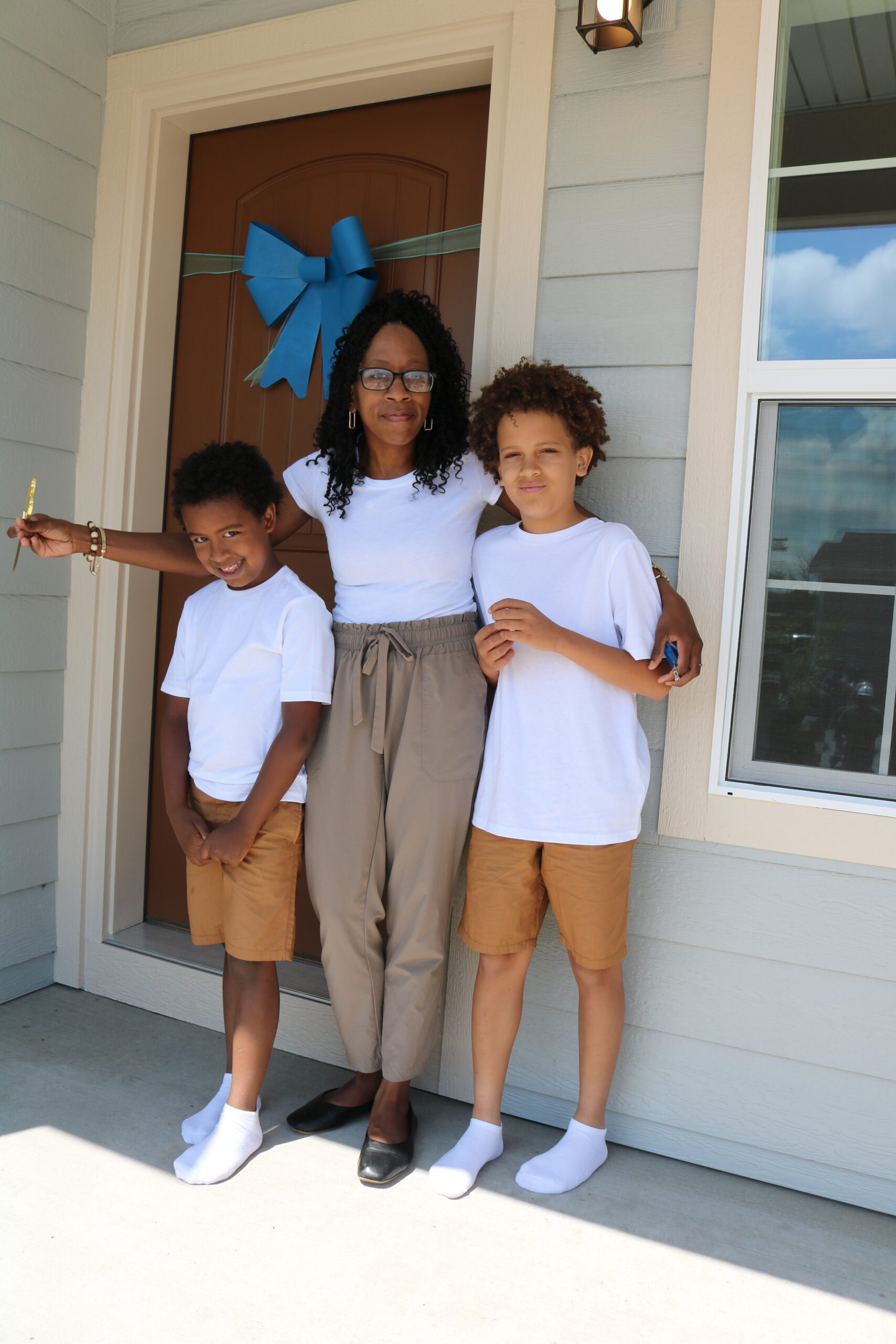 Woman and sons standing by front door