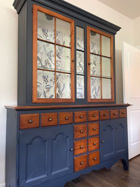Upcycled China hutch with wallpaper and colorful paint