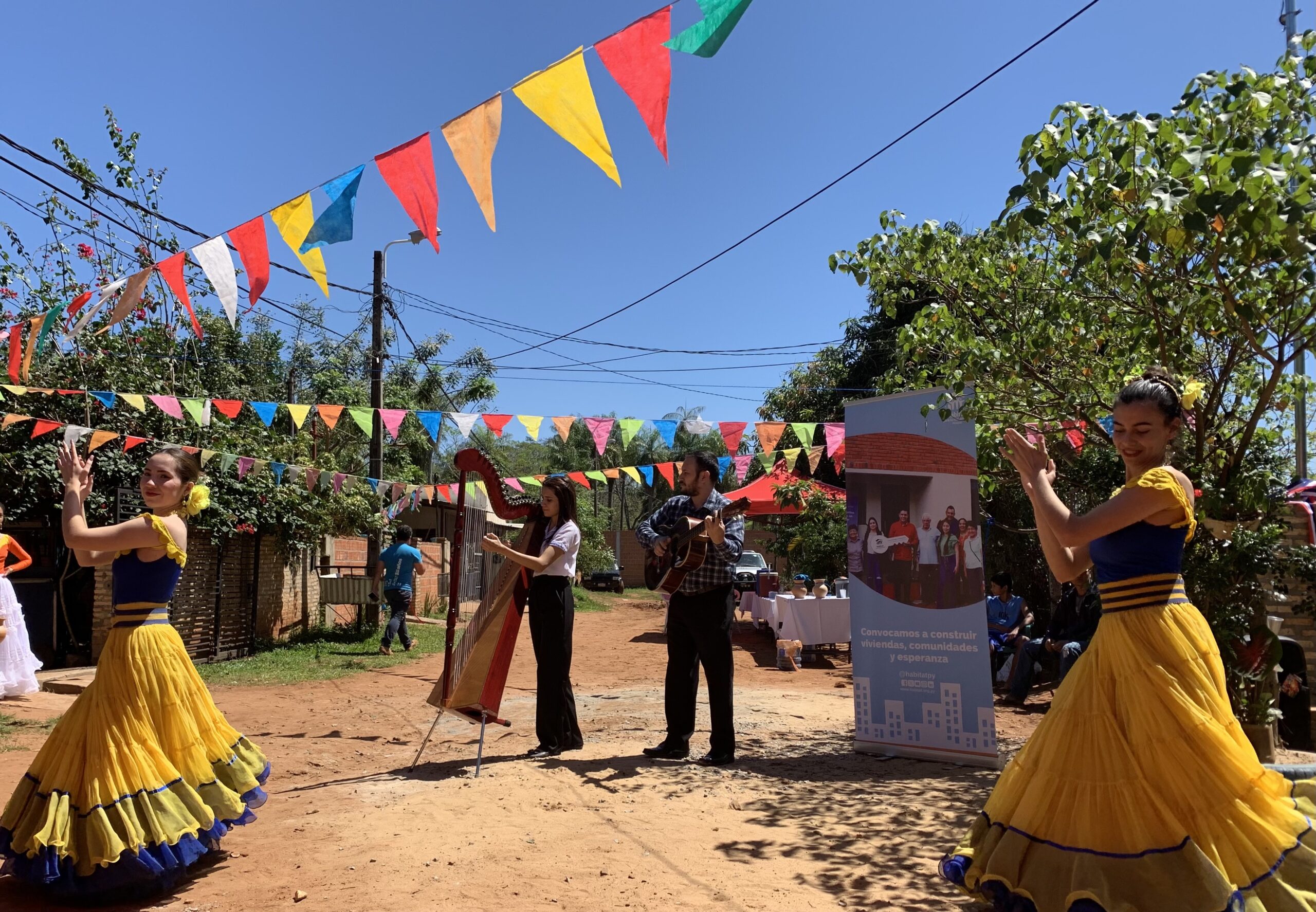 Women in blue and yellow dresses dancing