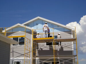 Volunteers work on a scaffolding