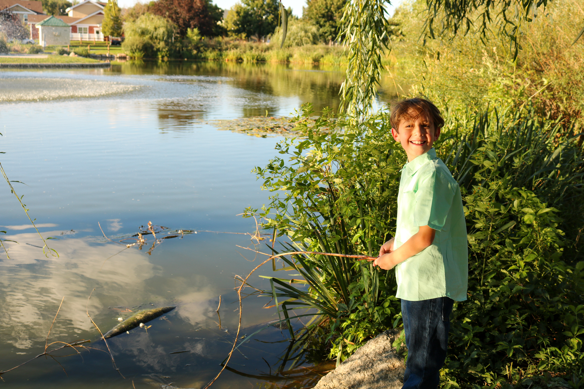 Boy fishing in pond
