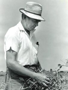 Black-and-white photo of a man in a field