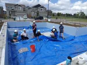 People standing on membrane in home foundation