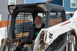Gary driving the Bobcat on the construction site