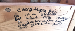 Board with blessing written in photo caption