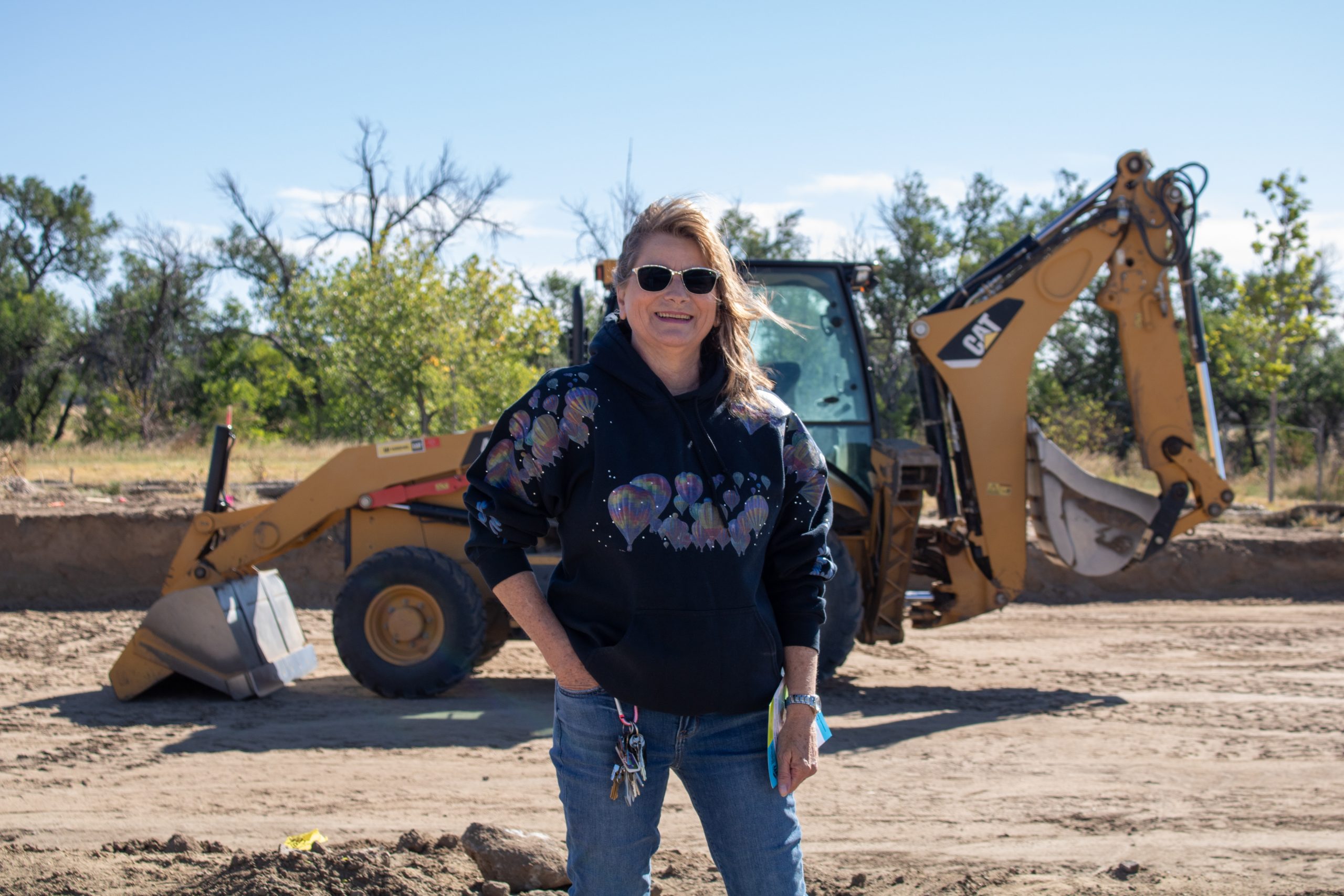 Woman standing in front of a bulldozer