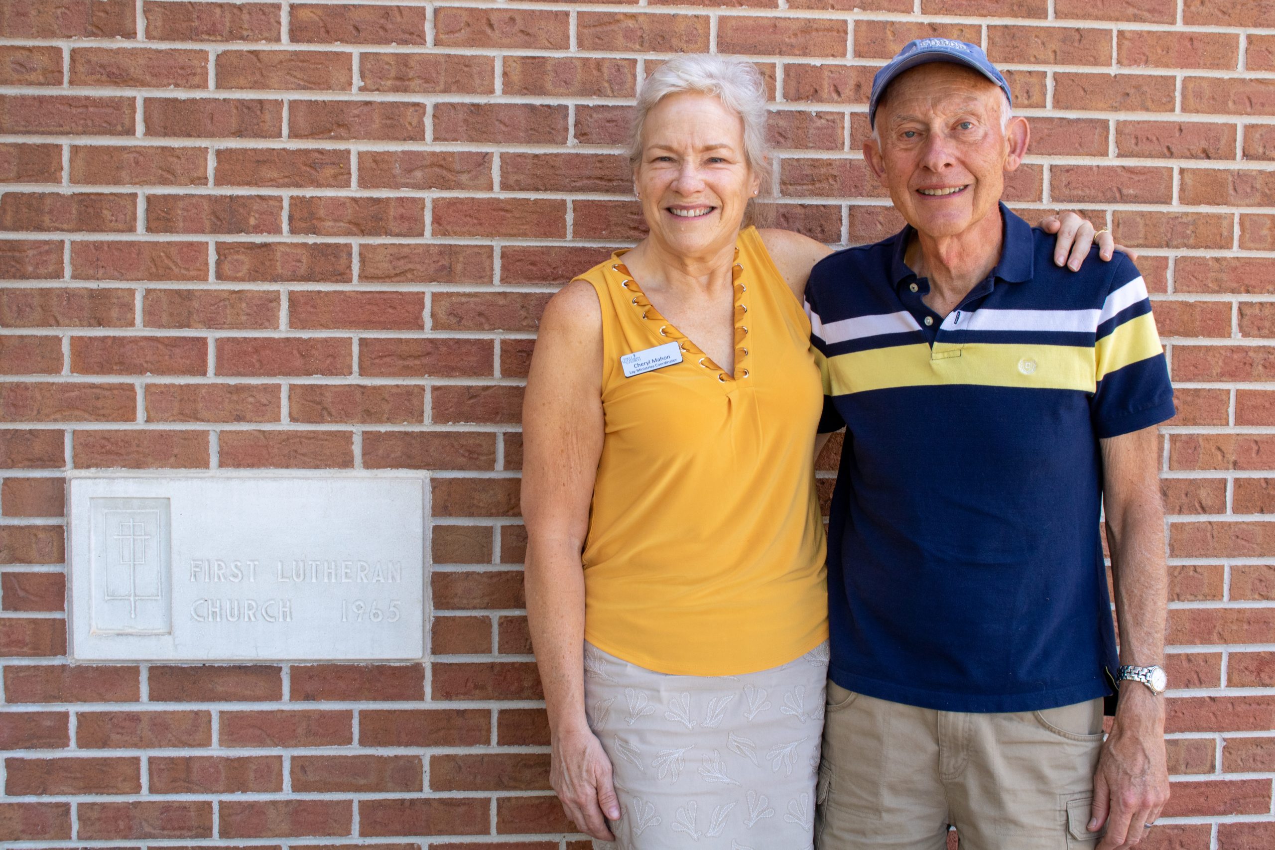 People standing by church sign