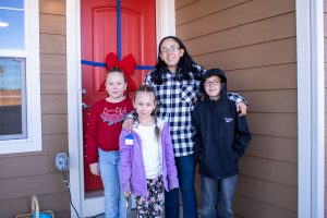 Family standing in front of door