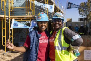 Women hugging on a construction site