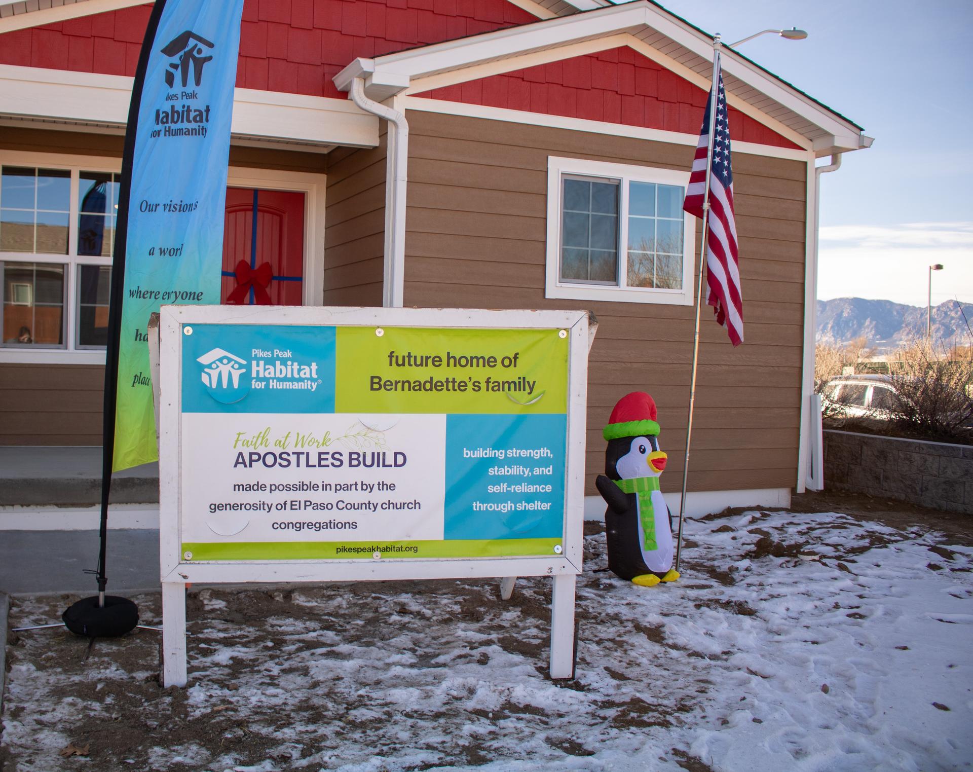 House with build sign and penguin