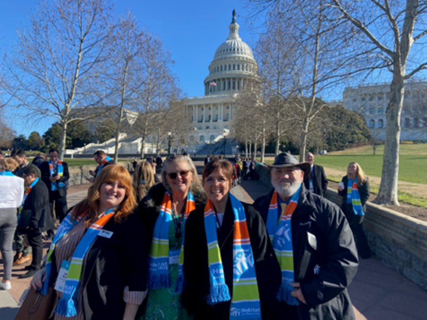 Four people standing in front of Capitol Building