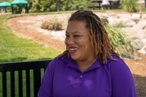 Smiling woman on a park bench