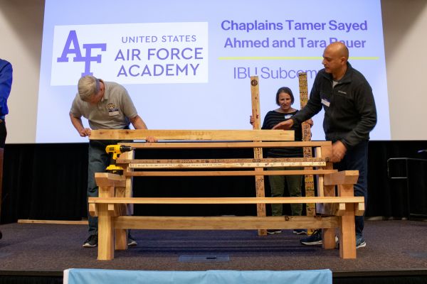 Jeff Mawhirter assembles the Unity Bench with help from USAFA chaplains