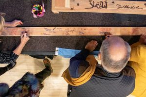 People signing bench