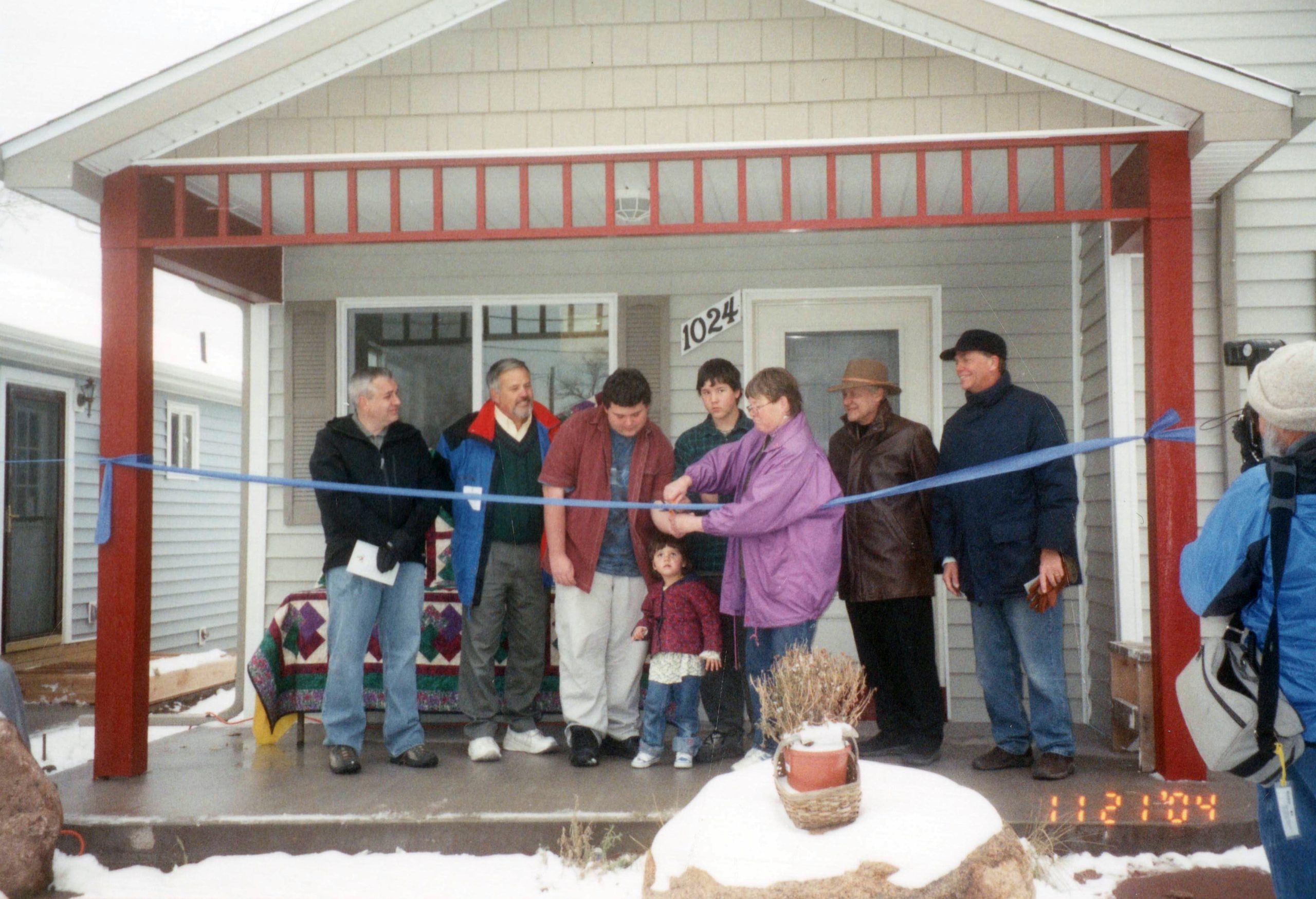 Ribbon cutting in front of home
